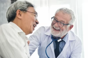 Elder Care - gentleman speaking with doctor about flu and cold season